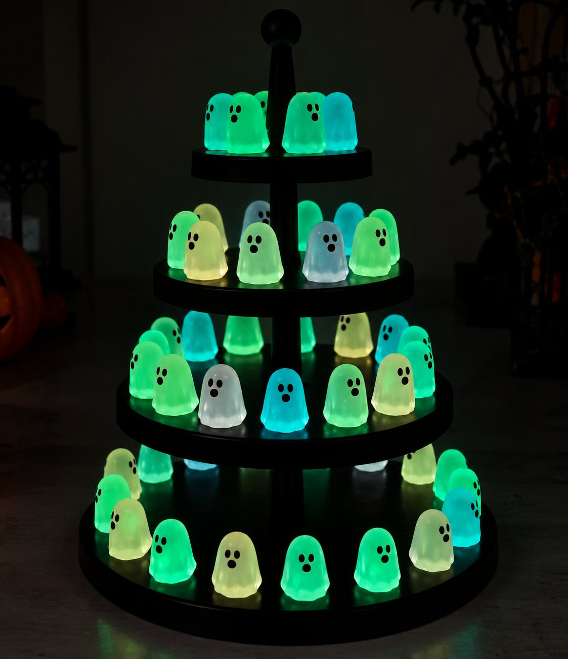 Glow-in-the-Dark Mini Ghosts on tiered display stand in the dark