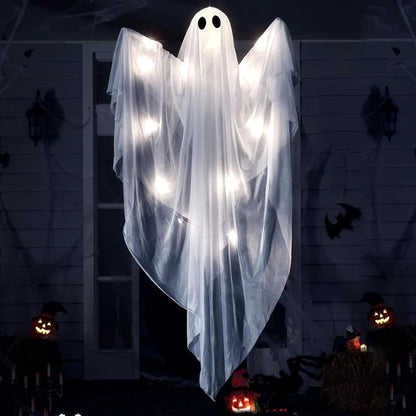 LED Hanging Ghost in front of a dark house with jack-o'-lanterns