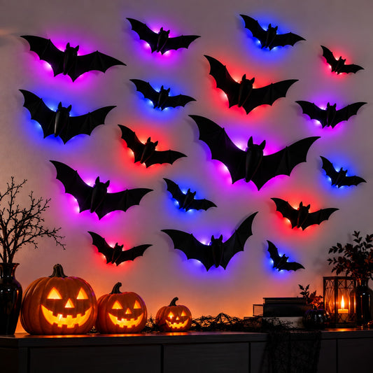 3D Bat Lights glowing on a wall above carved pumpkins